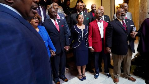 Members of the Mississippi Legislative Black Caucus hold hands and sing 