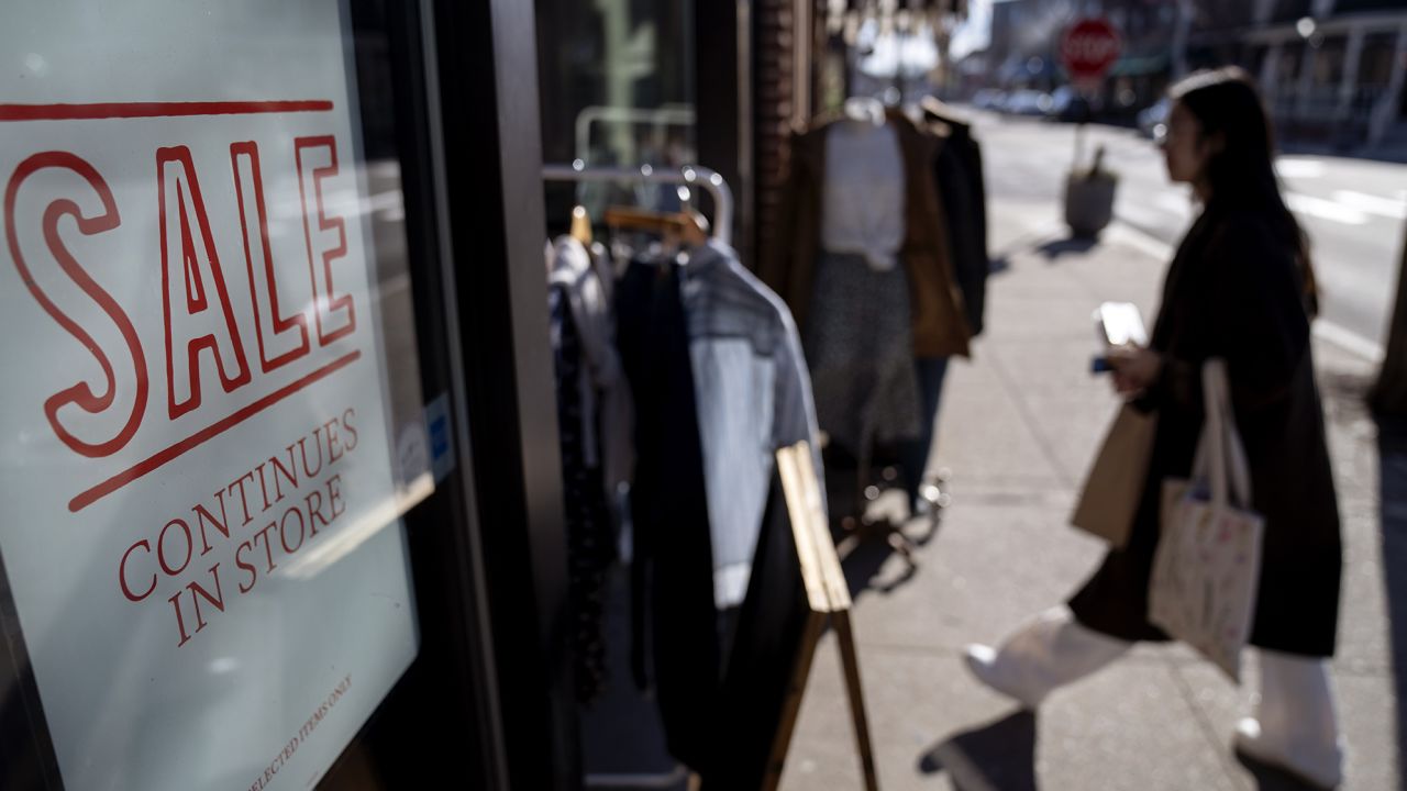 A shop holds a sidewalk sale during an unseasonably warm day, Friday, Feb. 10, 2023, in Providence, R.I.
