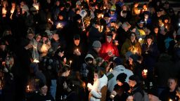 Mourners attend a candlelight vigil for Alexandria Verner at the Clawson High School football field in Clawson, Mich., Tuesday, Feb. 14, 2023. 
