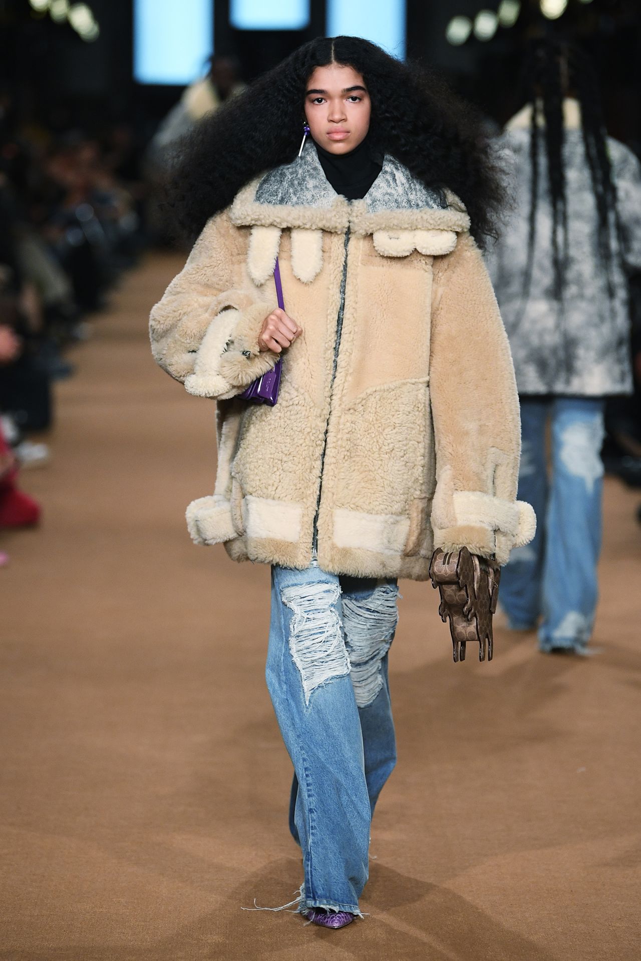 Coach's latest outing celebrated a new generation of classic American styles, including shearling coats, denim skirts, leather jackets and patent mini backpacks.
