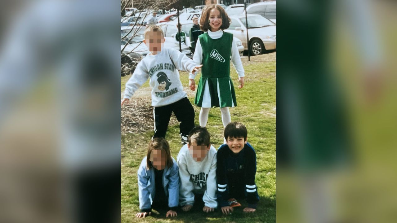 Goldynia and her brother in 1998 before a Michigan State football game. A portion of this image has been blurred by CNN for privacy. 
