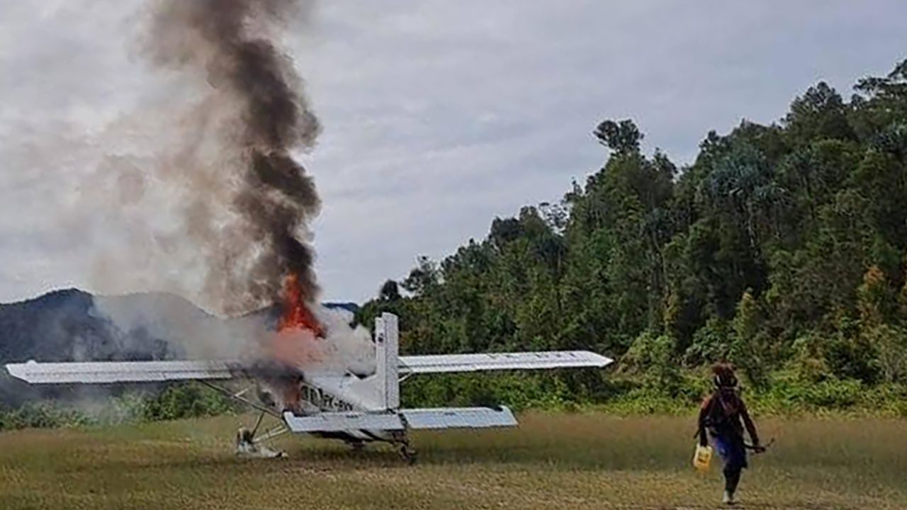 West Papua separatist fighters released images of the New Zealand pilot's plane on fire.
