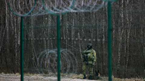 A Belarusian border guard patrols near the Divin border crossing point between Belarus and Ukraine on Wednesday.