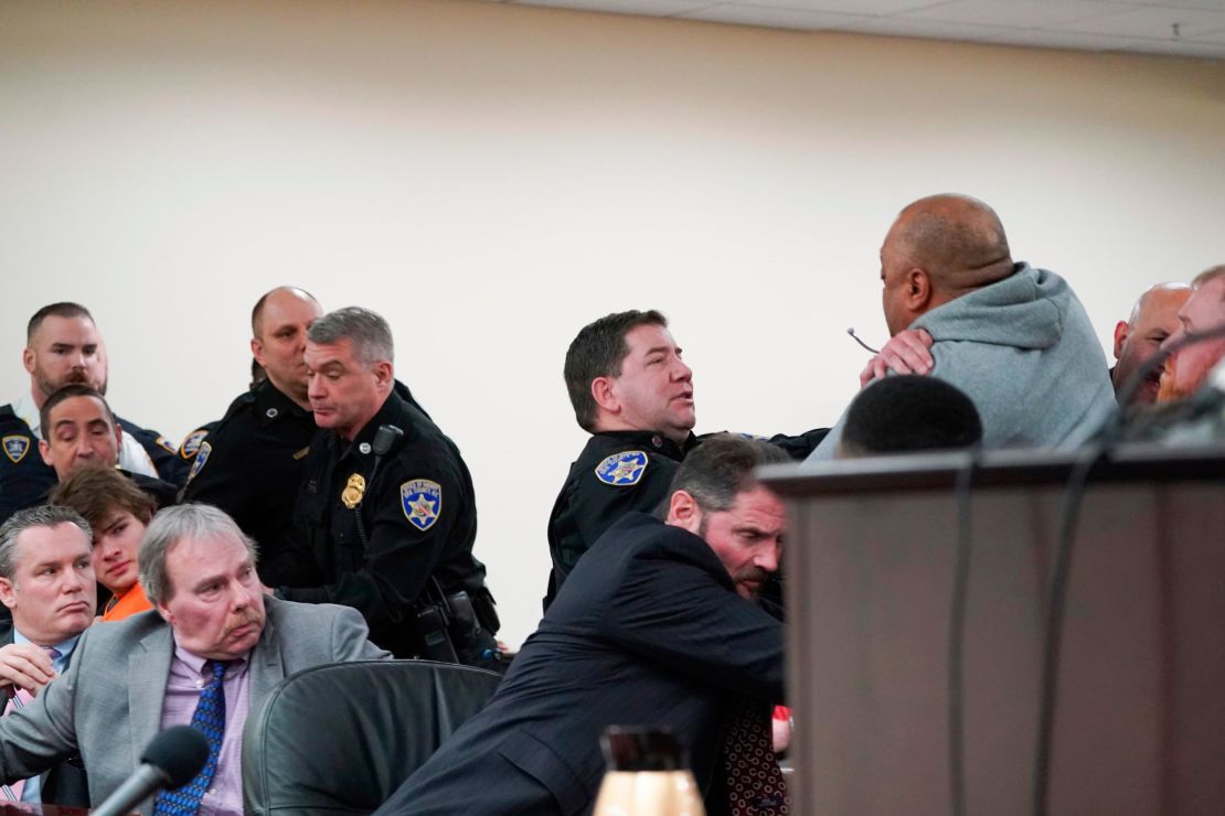 Assistant district attorney Gary Hackbush, bottom, helps deputies restrain a man who lunged toward Payton Gendron during the sentencing hearing on Wednesday.