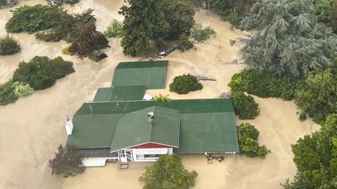 An NH90 helicopter and crew recover people from the rooftops of their homes in Esk Valley, Napier in this handout photo released on February 14, 2023.