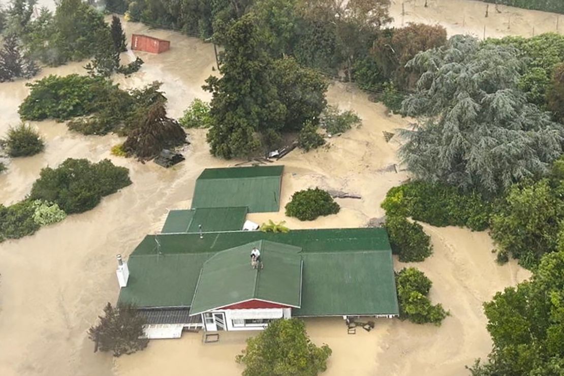 An NH90 helicopter and crew recover people from the rooftops of their homes in Esk Valley, Napier in this handout photo released on February 14, 2023.