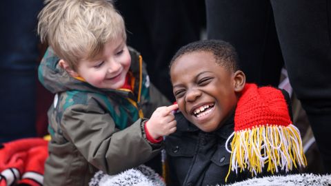 A couple of young Chiefs fans make most of the morning waiting for the Kansas City Chiefs' victory celebration and parade in Kansas City.