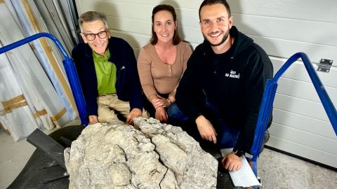 (From left) John Hudson, Marie Woods and Dean Lomax are shown with the dinosaur footprint.
