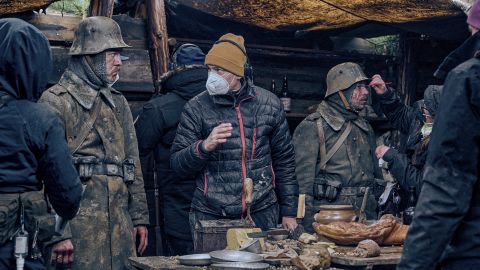 Actor Albrecht Schuch (left) and director Edward Berger (center) on location n the Czech Republic during the shoot of "All Quiet on the Western Front."