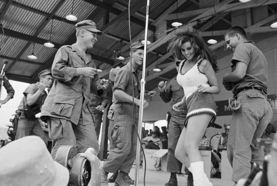 Welch dances on stage with a group of soldiers in Vietnam during a Bob Hope USO show in 1967.