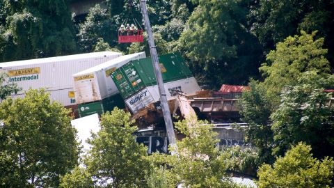 Workers in a gondola look over derailed freight cars in August 2018 on Pittsburgh's south side.