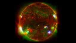 This composite image of the Sun includes high-energy X-ray data from NASA's Nuclear Spectroscopic Telescope Array (NuSTAR) shown in blue; lower energy X-ray data from the X-ray Telescope (XRT) on the Japanese Aerospace Exploration Agency's Hinode mission shown in green; and ultraviolet light detected by the Atmospheric Imaging Assembly (AIA) on NASA's Solar Dynamics Observatory (SDO) shown in red.