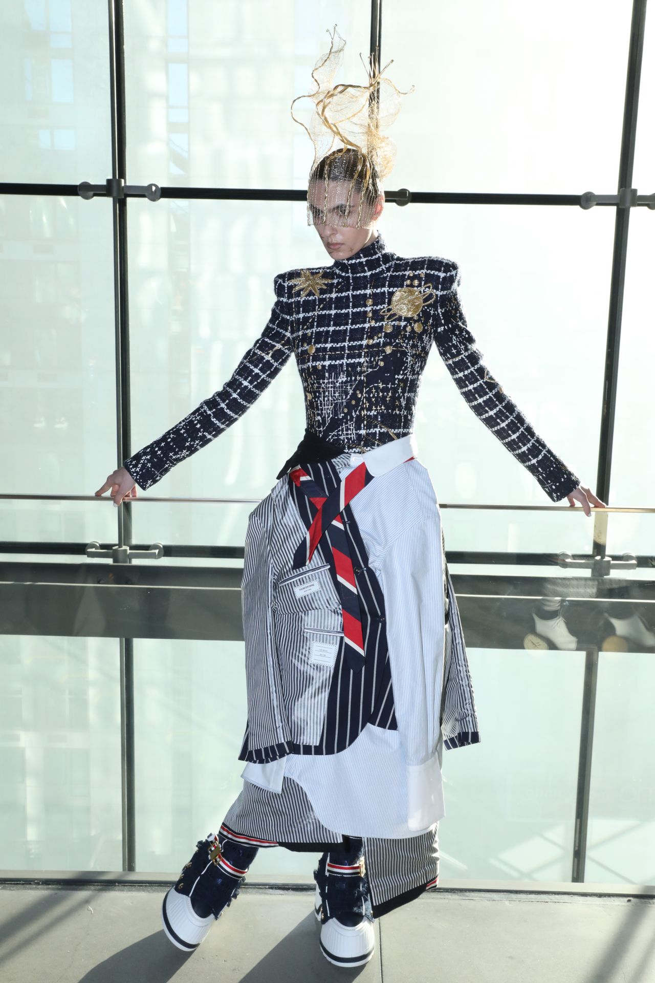 Accessories at Thom Browne's half-hour stage show included delicate hand-crocheted gold wire headpieces, clock handbags and shoes, and platform astronaut boots.