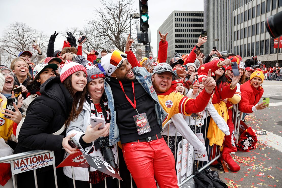 Kansas City Chiefs safety Juan Thornhill celebrates with fans during the parade.