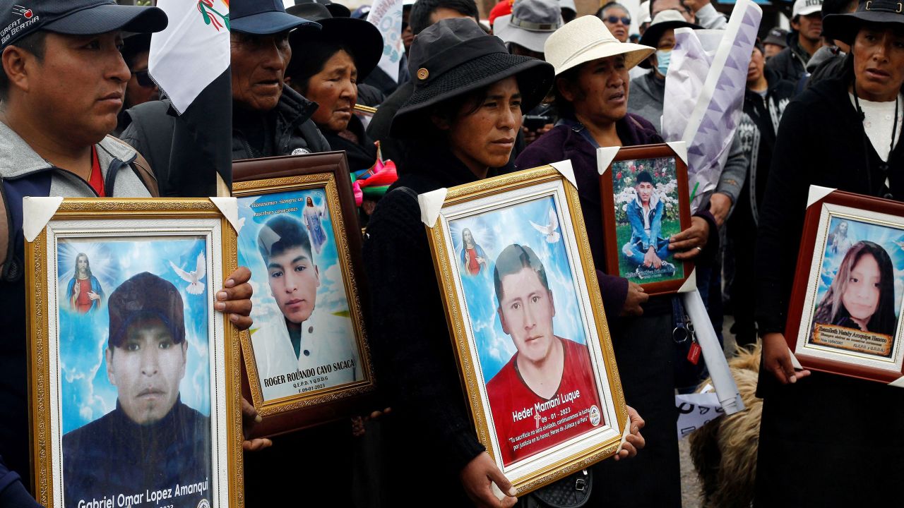 Relatives and friends of victims of recent clashes with the Peruvian police -- within protests against President Dina Boluarte -- carry pictures of their loved ones during a march commemorating one month of their death on February 9, 2023, in Juliaca, Puno region.