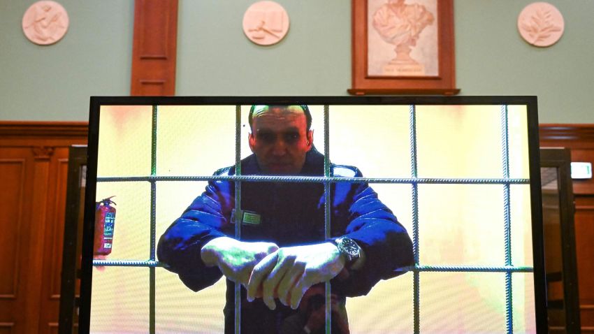 TOPSHOT - Opposition leader Alexei Navalny appears on a screen set up at a courtroom of the Moscow City Court via a video link from his prison colony during a hearing of an appeal against his nine-year prison sentence he was handed in March after being found guilty of embezzlement and contempt of court, in Moscow on May 17, 2022. - Alexei Navalny's hearing comes as Russian authorities seek to silence remaining government critics and Moscow pushes on with its military campaign in neighbouring Ukraine, with thousands killed and some 10 million displaced. He is already serving two-and-a-half years in a prison some 100 kilometres (60 miles) east of Moscow for violating parole on old fraud charges. If his new sentence comes into force, the 45-year-old opposition politician will be transferred to a strict-regime penal colony, which will place him in much harsher conditions. The new sentence will replace the old one -- that he was handed in February last year -- meaning Navalny will remain behind bars for another eight years. (Photo by Kirill KUDRYAVTSEV / AFP) (Photo by KIRILL KUDRYAVTSEV/AFP via Getty Images)