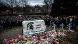 A makeshift memorial continues to grow with flowers and other keepsakes dedicated to the students killed and injured in Monday's shootings on campus, as a crowd gathers at The Rock, a popular college landmark on Wednesday, Feb. 15, 2023, at Michigan State University in East Lansing, Mich. (Jake May/The Flint Journal via AP)