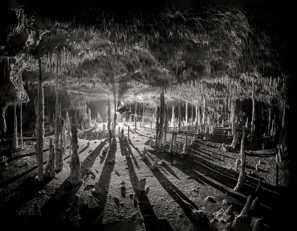 Martin Broen's atmospheric "Long Shadows" won first place in the Black and White category. The photo presents stalactites hanging from the roof of Cenote Dos Pisos, Mexico.