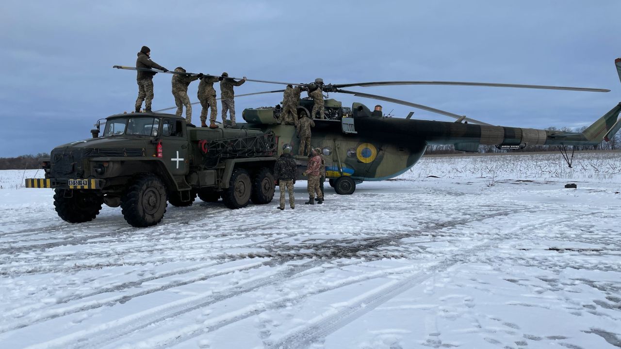 After striking a tree, engineers work to replace the blades on the Soviet-built Mi-8 helicopter.