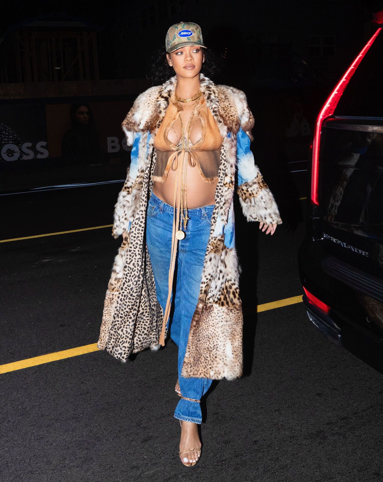 Once the cat was out of the bag, the bump was front and center — like in this Plein Sud Bikini top, allowing a Jacquie Aiche diamond, reportedly worth nearly $40,000, to peek through. The beauty mogul grounded the look with a tie dye coat and camo cap.