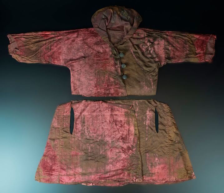 A velvet robe made with expensive red dye was found in the same chest as the gowns.