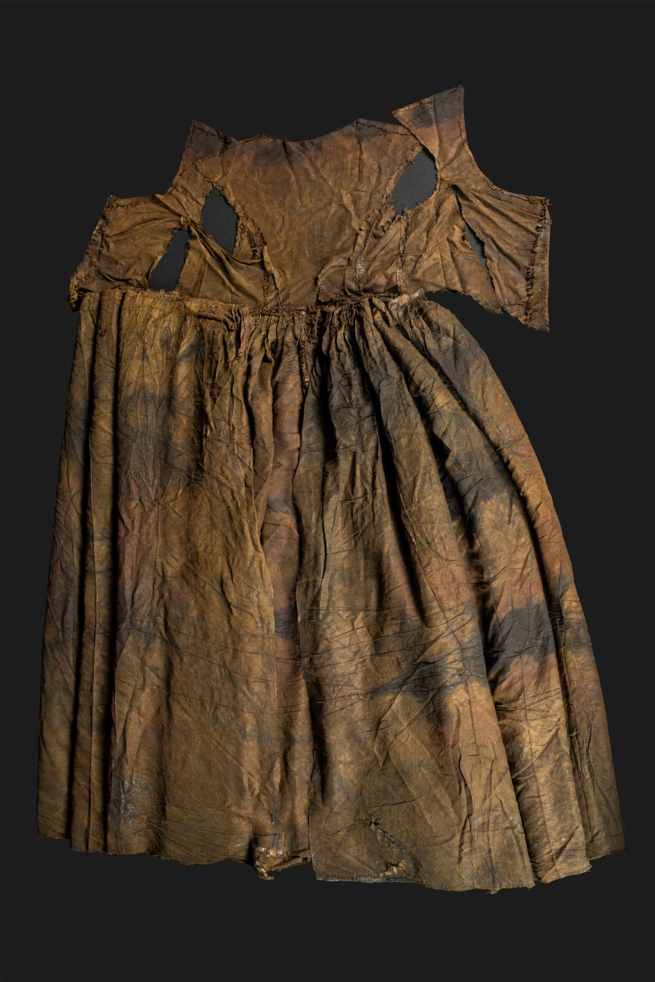 A silk wedding dress interwoven with pieces of silver was recovered from the same chest as the other silk dress. The two dresses are different sizes, suggesting the clothing belonged to a family rather than one person.