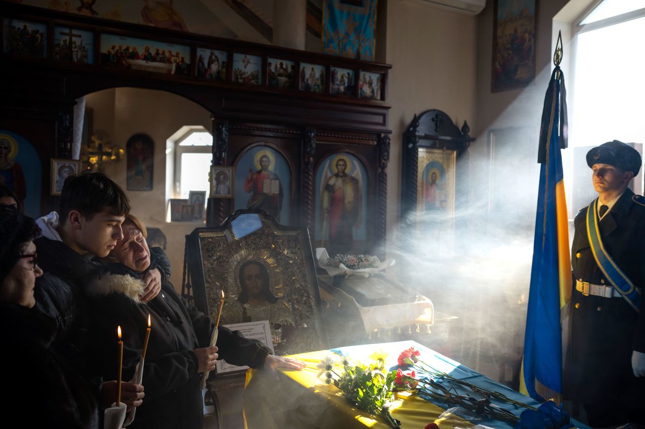 Svitlana is joined by her son Kyrylo at her husband's funeral in the Ukrainian village of Tarasivka on Wednesday, February 15. Serhii Havryliuk, 48, died in April while defending the Azovstal steel plant against the Russians. He was finally being buried after DNA tests confirmed his identity.