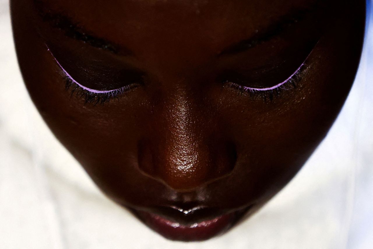 A model sits backstage after having makeup applied for a fashion show in New York on Monday, February 13.