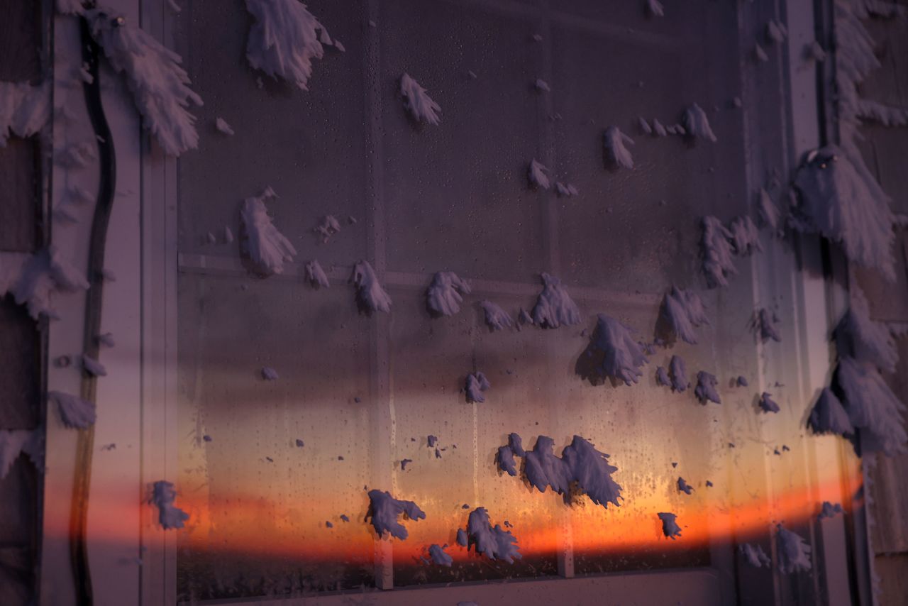 The sun illuminates a window speckled with ice at the top of New Hampshire's Mount Washington on Thursday, February 9. At just over 6,000 feet, the <a href="https://www.cnn.com/2023/02/06/weather/extreme-cold-mount-washington-wxn/index.html" target="_blank">Mount Washington Observatory</a> is situated in the perfect location for extreme winds and brutal cold.