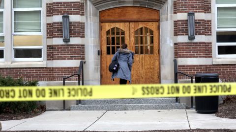 People retrieve belongings from Berkey Hall, which school officials say will remain closed for the rest of the semester.