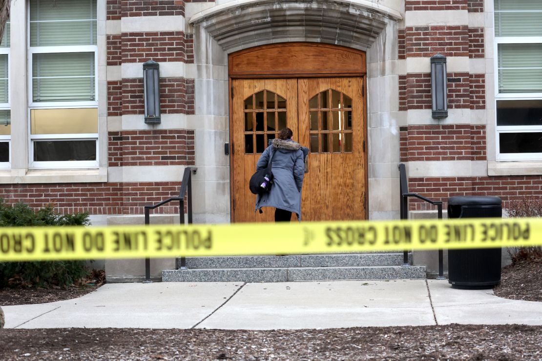 People retrieve belongings from Berkey Hall, which school officials say will remain closed for the rest of the semester.