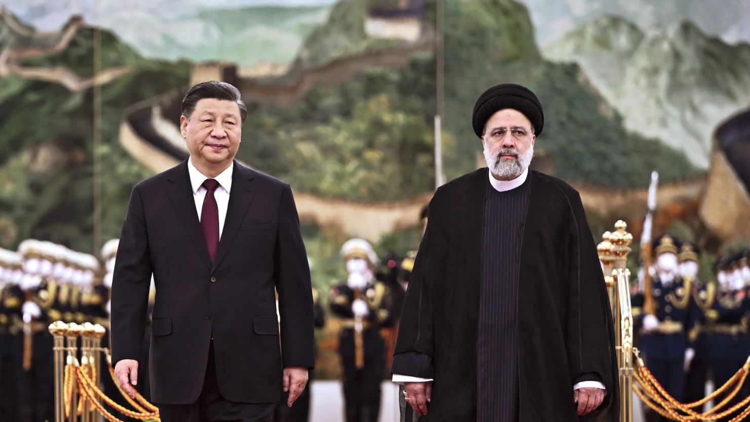 Iranian President Ebrahim Raisi walks with Chinese President Xi Jinping during a welcome ceremony at the Great Hall of the People in Beijing on Tuesday. 