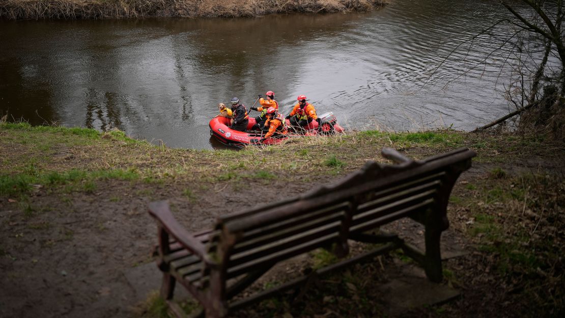 A search dog from Lancashire Police and a crew from Lancashire Fire and Rescue service search the River Wyre near the bench where Bulley's mobile phone was found, in the village of St Michael's on Wyre on February 1, 2023.