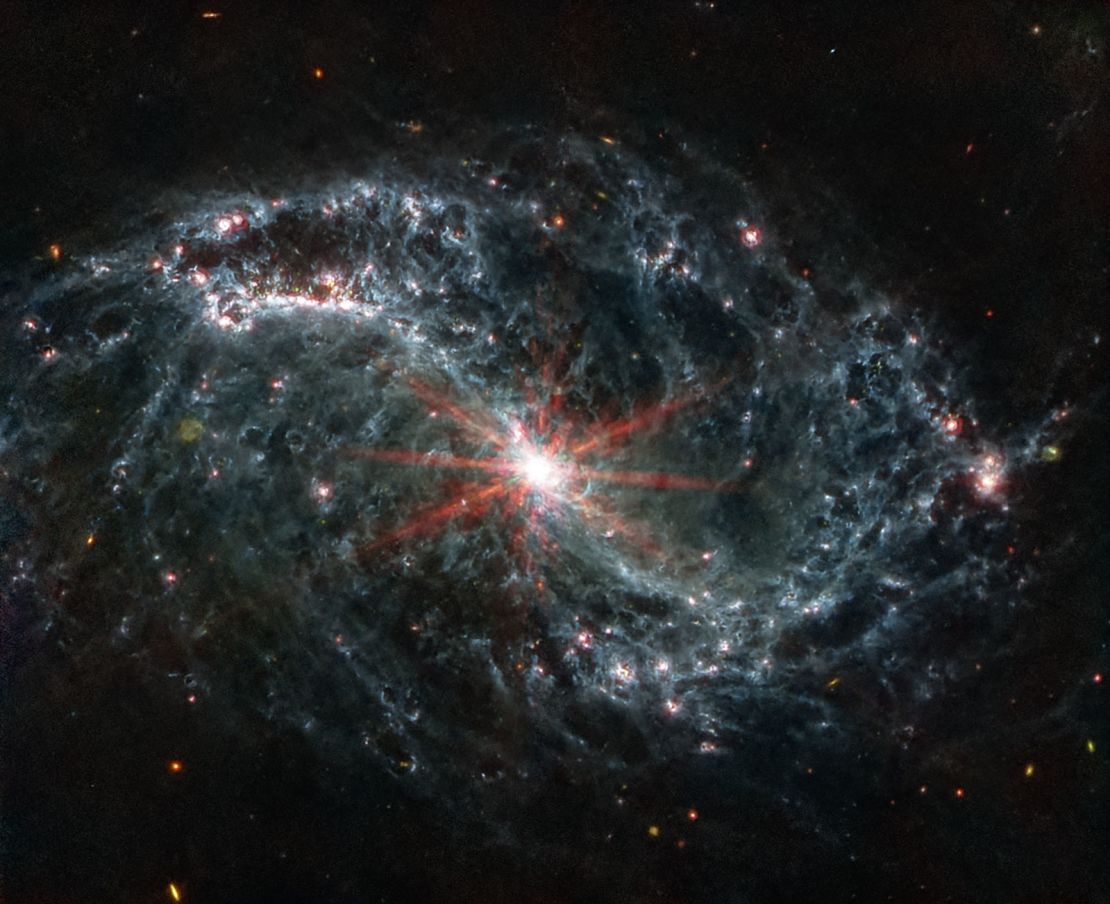 The spiral arms of galaxy NGC 7496 are filled with bubbles and shells created by young stars releasing energy.