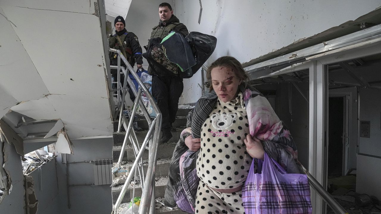 Marianna Vishegirskaya walks downstairs in of a maternity hospital damaged by shelling in Mariupol, Ukraine, Wednesday, March 9, 2022. Vishegirskaya survived the shelling and later delivered a baby girl in another hospital. (AP Photo/Evgeniy Maloletka)