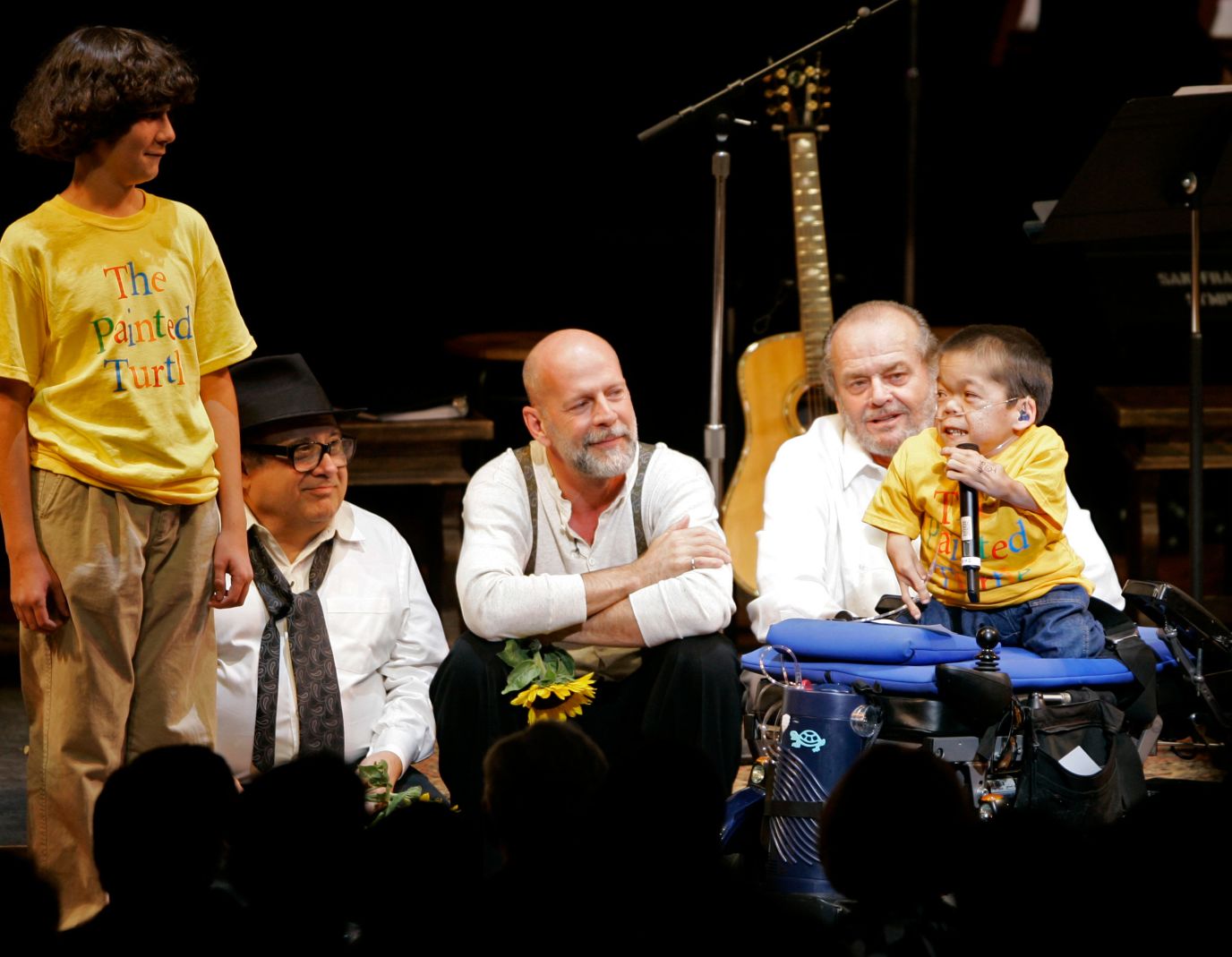 Willis and fellow actors Danny DeVito and Jack Nicholson listen to a boy give thanks during the curtain call for a staged reading of "The World of Nick Adams" in 2008. The event benefited the Painted Turtle, a camp and family care center founded by actor Paul Newman for children with life-threatening illnesses.