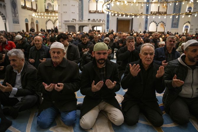 People pray for earthquake victims at Grand Camlica Mosque during the Lailat al Miraj in Istanbul on February 17.