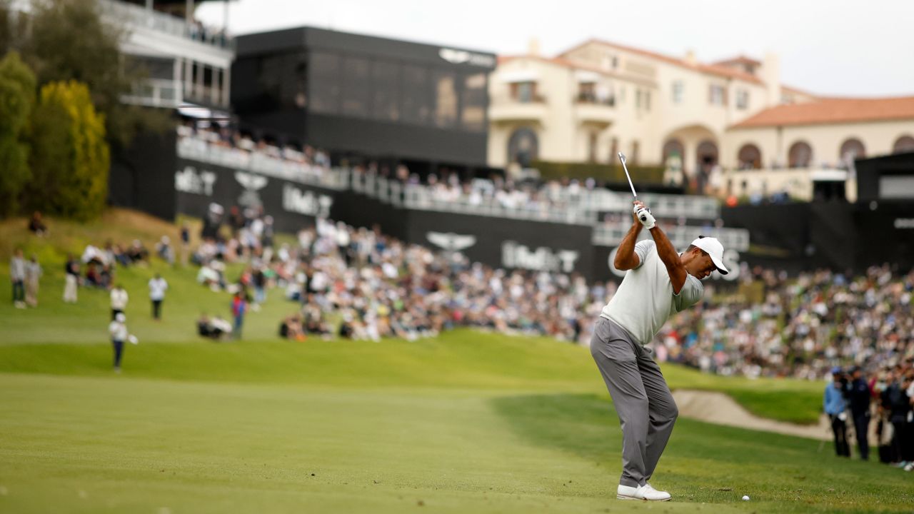 Tiger Woods plays his second shot on the 18th hole during the third round.
