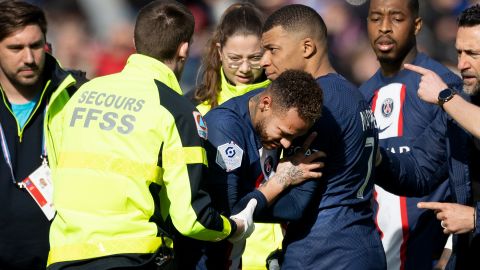 Neymar is comforted by Mbappé before being carried from the field on a stretcher.