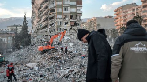 Rescuers search through the rubble of a collapsed building in Kahramanmaras after the deadly earthquake.