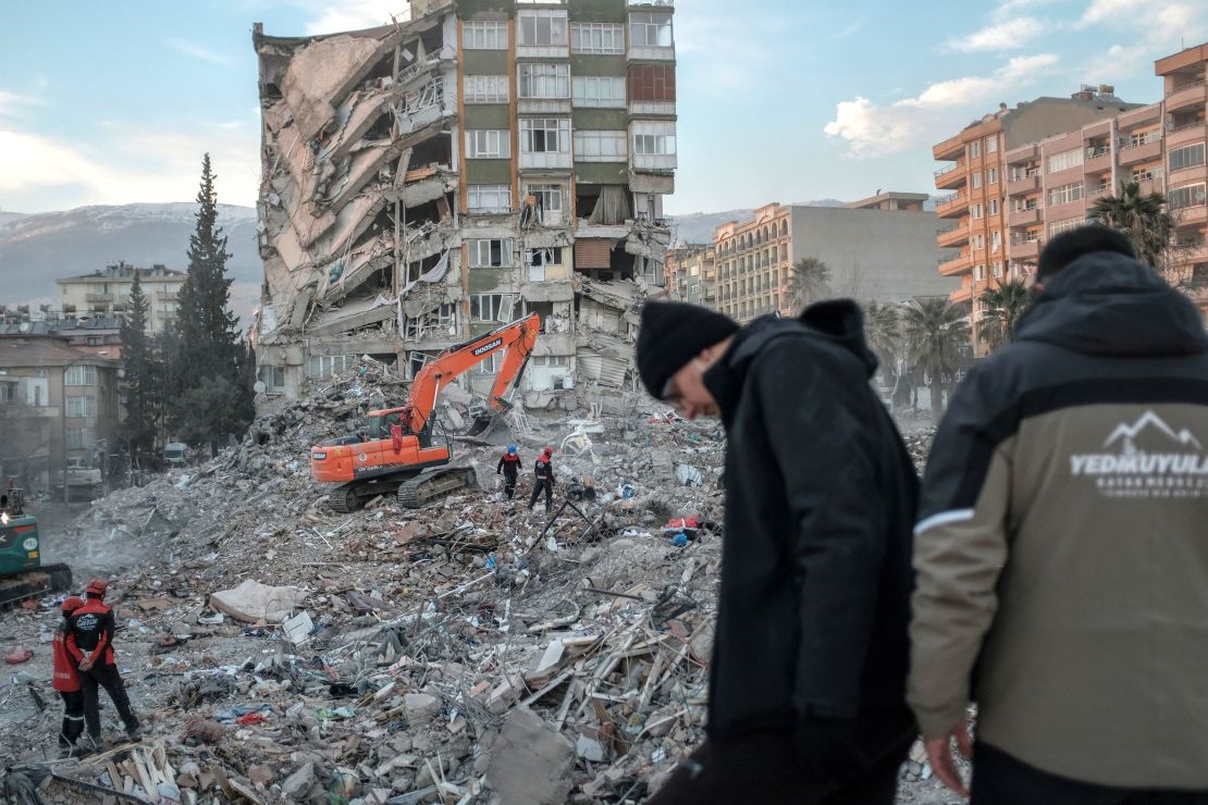 Rescuers search through the rubble of a collapsed building in Kahramanmaras after the deadly earthquake.