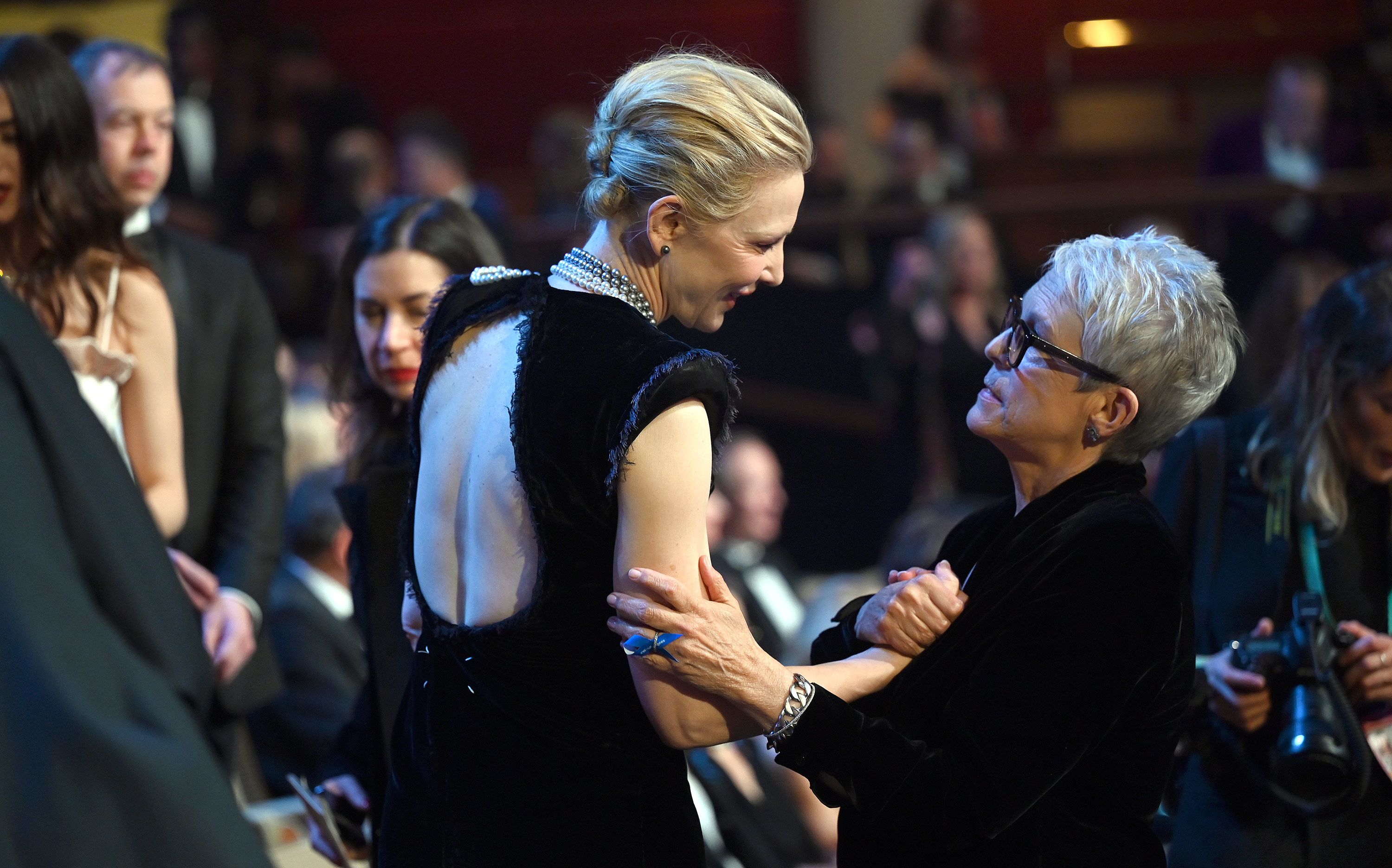 Cate Blanchett and Jamie Lee Curtis greet each other in the crowd.