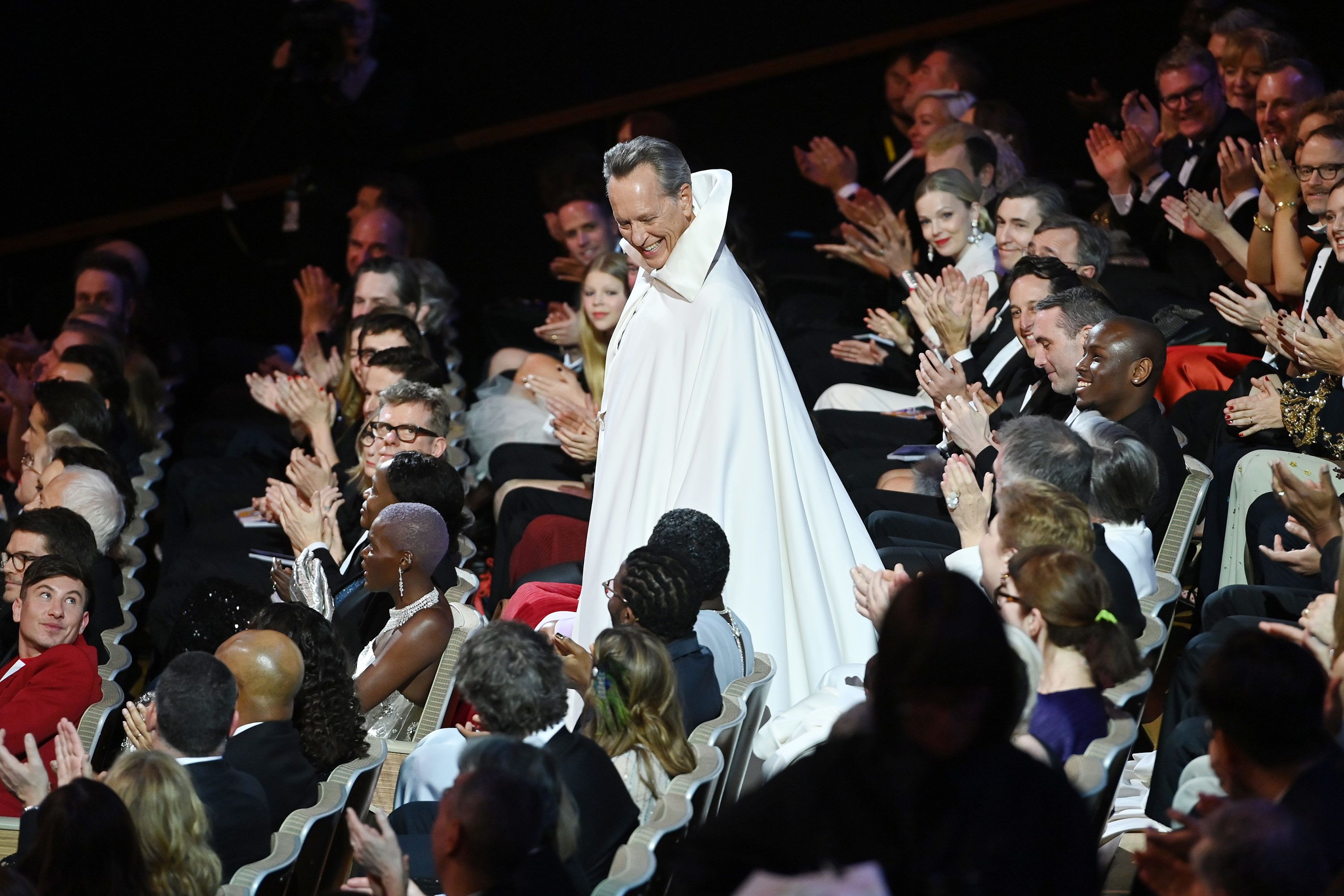 Host Richard E. Grant walks through the crowd.