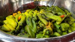 This July 12, 2021 image shows a large bowl of roasted green chile at a market in Hatch, New Mexico. Democratic Sen. Bill Soules is proposing that roasted green chile become the official state aroma. (AP Photo/Susan Montoya Bryan, File)