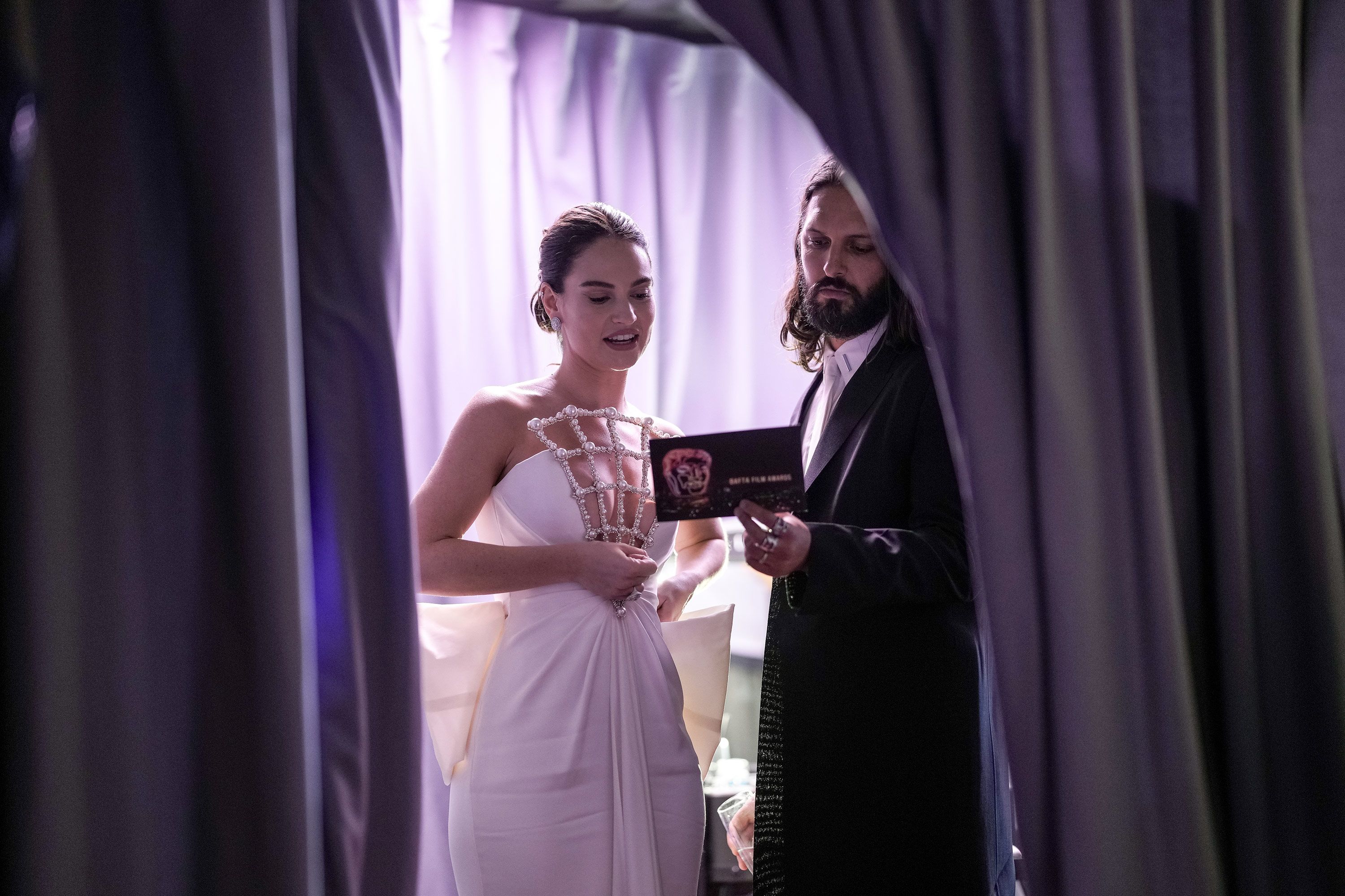 Presenters Lily James and Shazad Latif talk backstage.