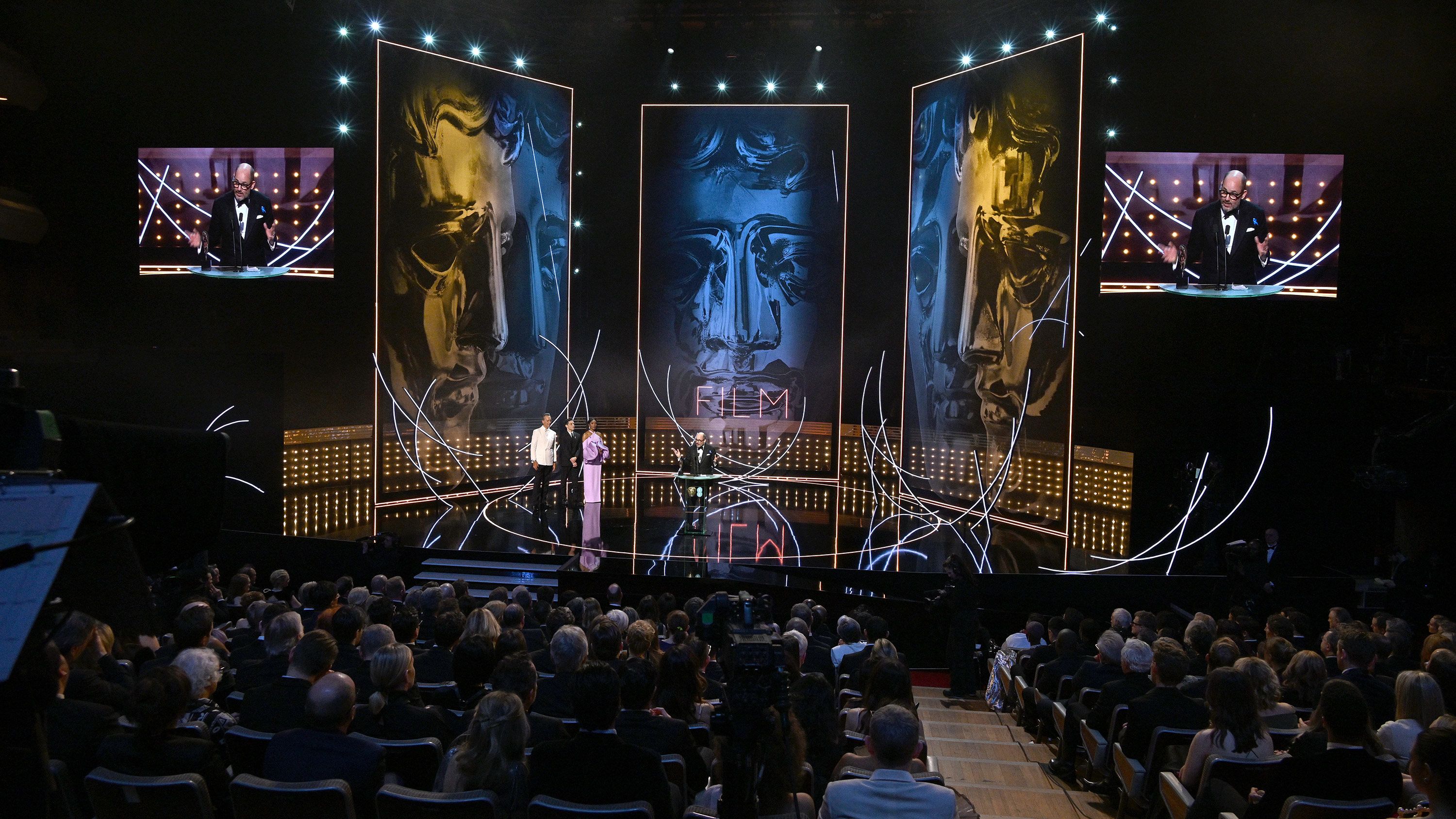 Edward Berger accepts the adapted screenplay award for All Quiet on the Western Front.