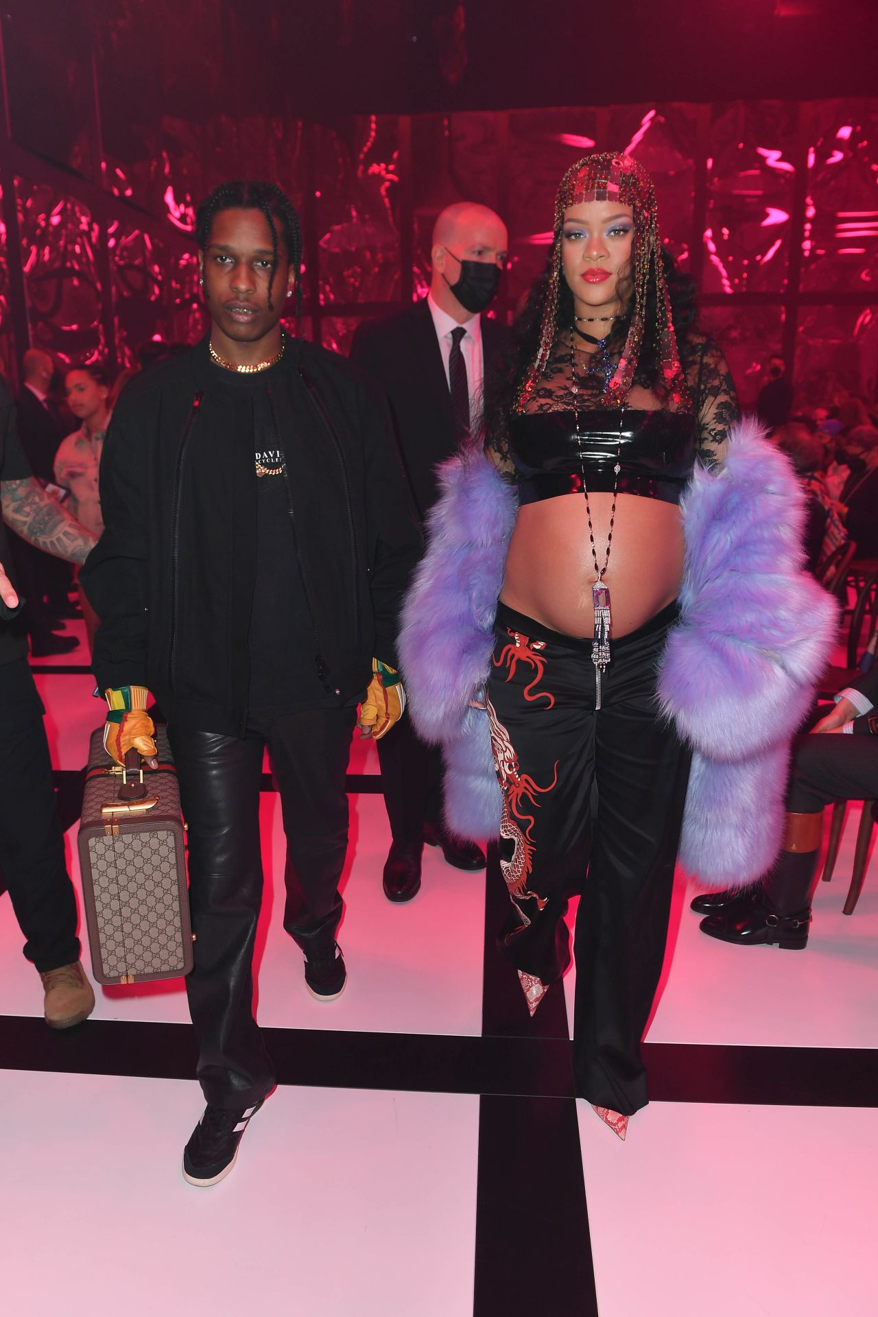 At the Gucci show in February 2022, Rihanna embodied the theme of the night — 'exquisite' — with her Gucci lilac faux coat, low-rise silky pants adorned with a dragon, and chain-mail headpiece. Of course, the singer let her bump shine through in a lace and latex crop top.