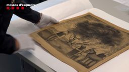 A Mosso d'Esquadra police officer handles a recovered charcoal drawing by Spanish artist Salvador Dali that had been stolen in Barcelona, Spain, in this handout photo released on February 17, 2023. Mossos d'Esquadra/Handout via REUTERS THIS IMAGE HAS BEEN SUPPLIED BY A THIRD PARTY MANDATORY CREDIT NO RESALES. NO ARCHIVES