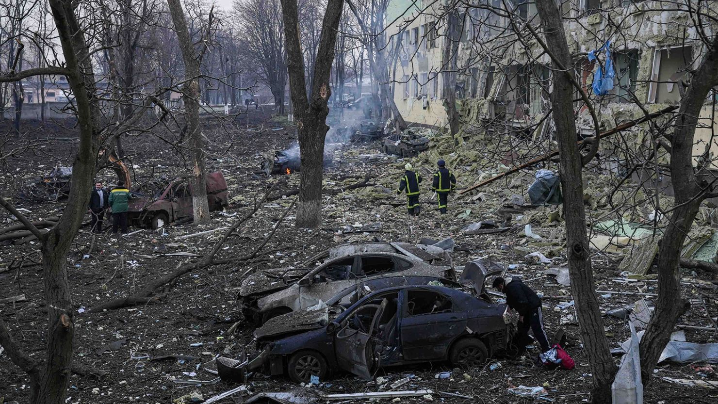 Ukrainian emergency employees work at a maternity hospital damaged by shelling in Mariupol, Ukraine, on Wednesday, March 9, 2022. 