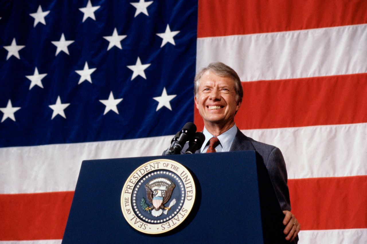 (Original Caption) 3/24/1979-Elk City, Oklahoma: President Jimmy Carter addressing a town meeting. American flag is hung in background.